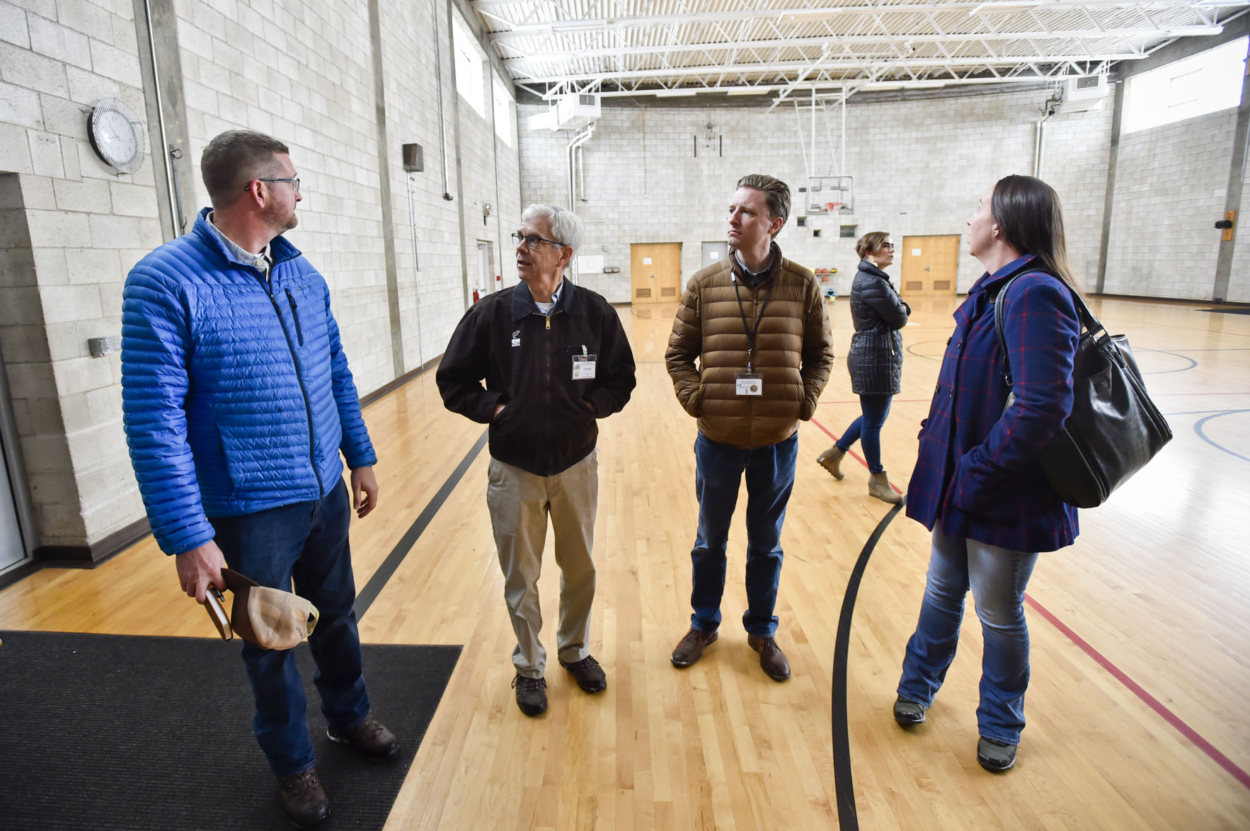 Lt. Gov. Mike Cooney and Chief Deputy Attorney General Jon Bennion, center, receive a tour of the former Montana Developmental Center